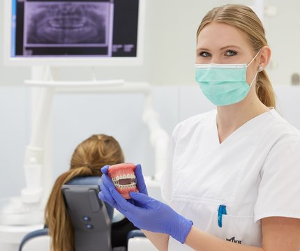 Zahnmedizinische Fachangestellte am UKR unterstützt bei einer zahnärztlichen Untersuchung